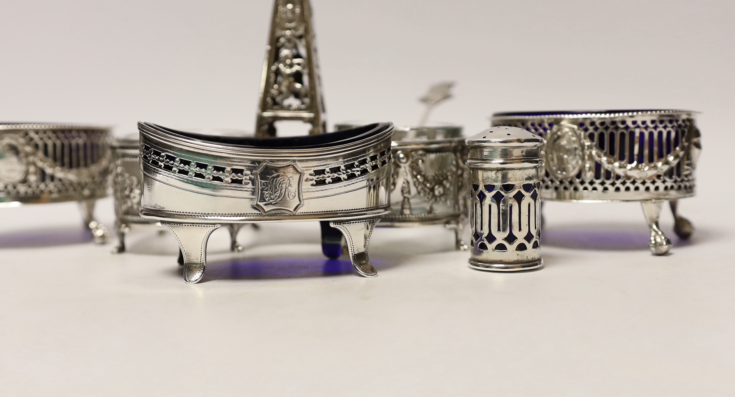 A French pierced white metal double condiment stand, height 14.6cm and four other silver condiments including pair of George III silver salts by Daniel Holy & Co.